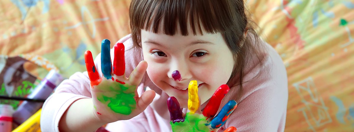 Disability Care Sunshine Coast - Girl with a Disability having fun painting with fingers