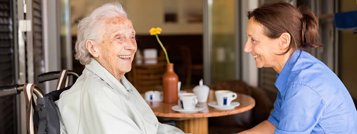 Personal Care Staffing - Female Carer caring for senior citizen